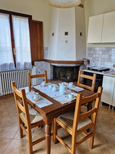 a kitchen with a wooden table with four chairs at casa vacanze sweet home in San Giovanni in Marignano