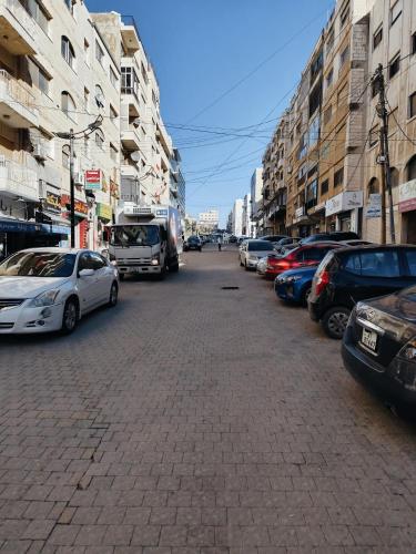 a street with cars parked on the side of the road at Gentle Breeze Studio 1 in Amman