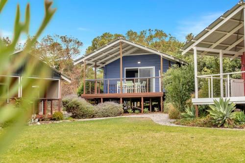 a house with a large porch and a deck at Blue Cabin Bliss at Aldinga Bay Holiday Village in Aldinga Beach