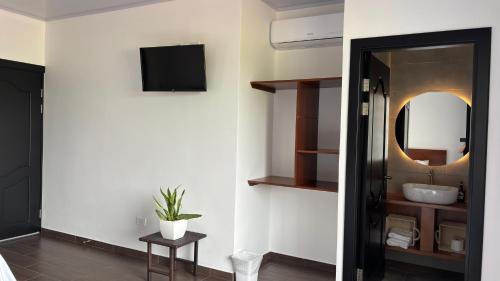 a bathroom with a sink and a mirror at Arenal Monara in Fortuna