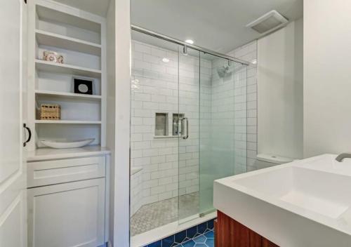 a bathroom with a glass shower and a sink at Grand 3 BD 2 BA House With Pool in Jacksonville Beach