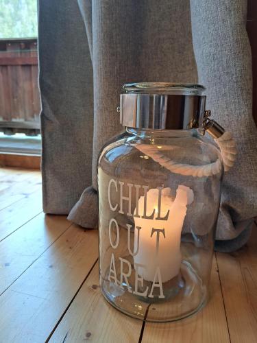 a glass jar with a candle in it on the floor at Naturetouch in Steinberg am Rofan