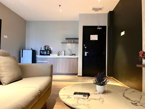 a living room with a couch and a table at HillLand Suites in Ayer Keroh