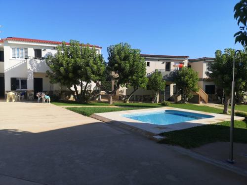 a house with a swimming pool in the yard at Cala en Forcat in Cala en Forcat
