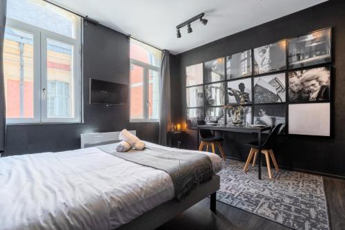 a bedroom with a bed and a desk in it at Studio located on the Grand Place! in Lille