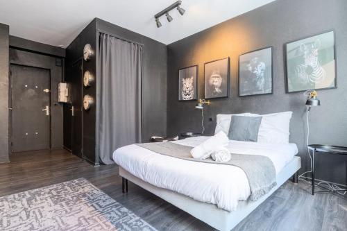 a bedroom with a large white bed in a room at Studio located on the Grand Place! in Lille