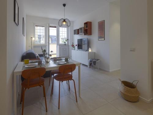 a kitchen with a table and chairs in a room at Attic with terrace on Conca d'oro in Rome