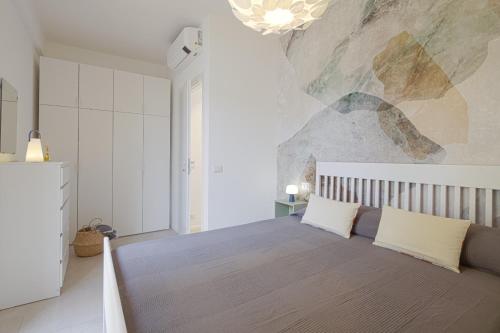 a bedroom with a large bed with a stone wall at Attic with terrace on Conca d'oro in Rome