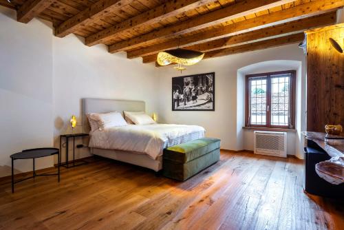 a bedroom with a bed and a wooden floor at Relais Villa Carrara in Villa di Serio