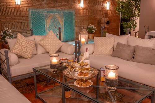 a living room with a couch and a table with candles at Dar Ines - Palmeraie, 250m2, pool, patio, terrace in Marrakech