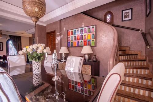 a dining room with a table and some chairs at Dar Ines - Palmeraie, 250m2, pool, patio, terrace in Marrakech