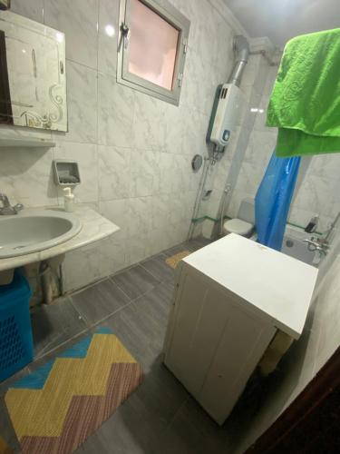 a bathroom with a sink and a toilet and a mirror at Live with local in central area in Cairo