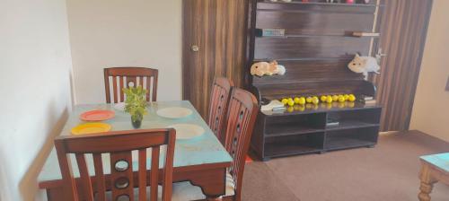 a dining room with a table and chairs and a table and chairsktop at Alan's 3BHK in Nainital