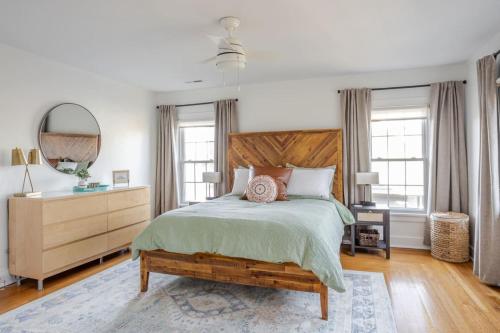 a bedroom with a bed and a dresser and a mirror at Avon Hills Quiet, 4B 1920s Tudor with Vintage Charms in Cincinnati