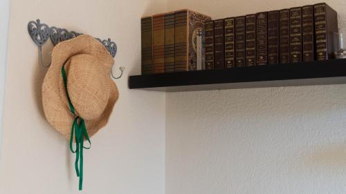 a shelf with books and a towel on it at Villa Il Casale Onifai in Onifai
