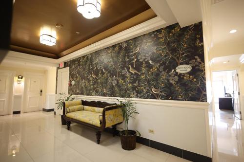 a couch in a hallway with a wall mural at Courtleigh Hotel & Suites in Kingston