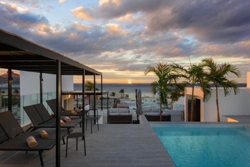 a balcony with a pool and a view of the ocean at Coralia Boutique Hotel Cozumel in Cozumel