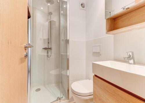 a bathroom with a shower and a toilet and a sink at Apt Ca na Claire in Port de Pollensa