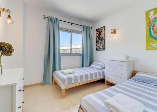 1 dormitorio con 2 camas y ventana en Apt Ca na Claire en Puerto Pollensa