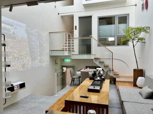 a living room with a staircase and a table at 沐正農場 嘉義包棟民宿 in Zhongpu