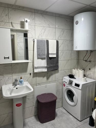 a bathroom with a washing machine and a sink at The Loft in Kumanovo