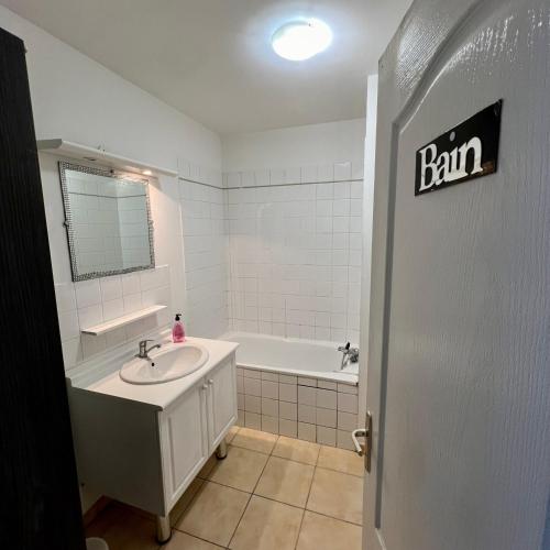 a bathroom with a sink and a bath tub at Thubaneau St Charles Canebière Vieux port in Marseille