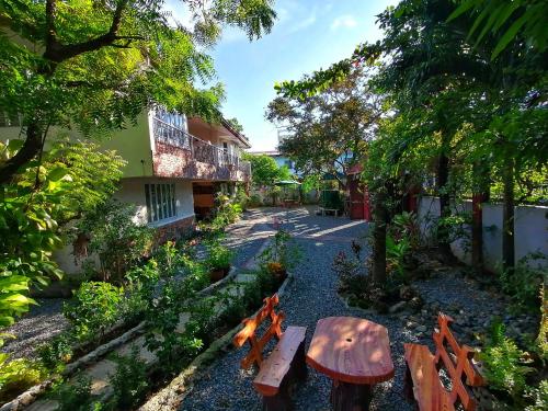 a wooden bench sitting in the middle of a street at Monte Rio Gardens Bed & Breakfast in Alaminos