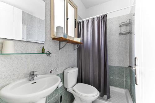 a bathroom with a white toilet and a sink at Sunny View - A Stunning Apartment With Private Rooftop in Paphos City