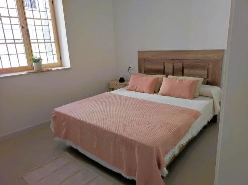 - une chambre dotée d'un lit avec des draps roses et 2 oreillers dans l'établissement Casa Vacaciones ALMADRABA CABO COPE, à Águilas