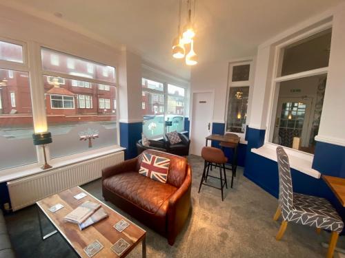 a living room with a couch and a table at The Fossil Tree Hotel in Blackpool