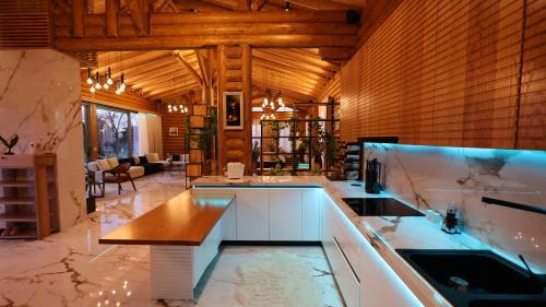 a large kitchen with white counters and wooden walls at Beautiful House - Luxury Villa for Rent in Bërxull