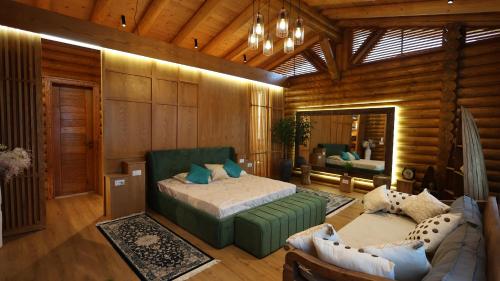 a bedroom with a bed and a couch in a room at Beautiful House - Luxury Villa for Rent in Bërxull