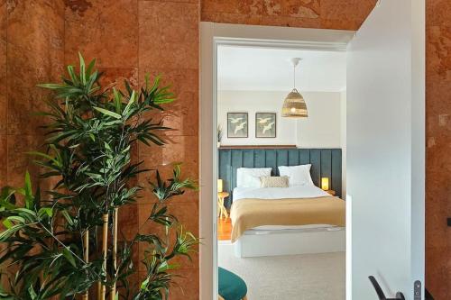 - une chambre avec un lit et une plante dans l'établissement Sweet Formosa View, à Faro