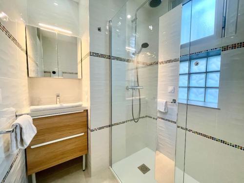 une salle de bain avec une douche en verre et un lavabo dans l'établissement Dolce Vita, T4 avec clim, pkg, à Montpellier
