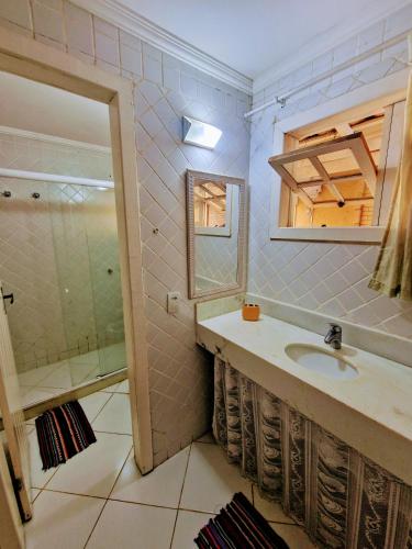 a bathroom with a sink and a shower at CASA DA EDINHA in Búzios