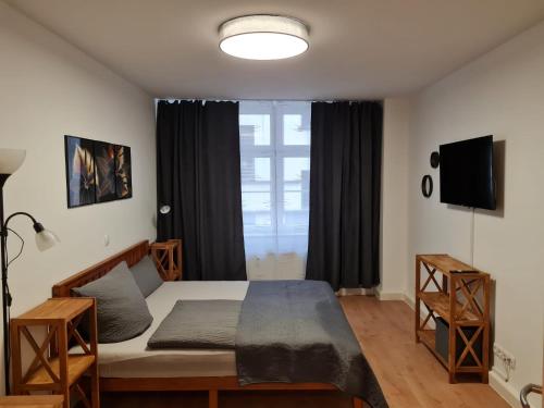 a bedroom with a bed and a large window at City Pension Zwickau in Zwickau