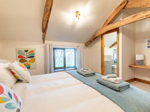 a bedroom with a large white bed and a window at 2 Bed in Bude 64088 in Marhamchurch