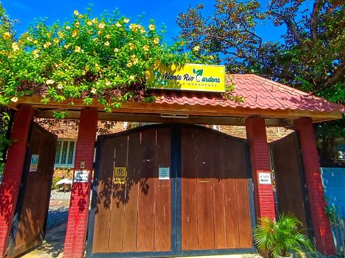 a garage with a sign on top of it at Monte Rio Gardens Bed & Breakfast in Alaminos