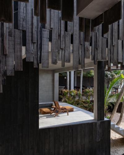 a room with a table and a bench in a building at UMi Tulum in Tulum