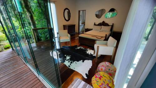 a view of a bedroom with a bed and a balcony at Casa da Mata in Itapema