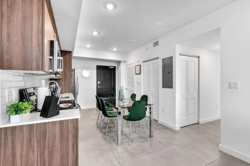 a kitchen and dining room with a table and chairs at Gorgeous 3-Bed Retreat Mins from Bayside and Parking in Miami