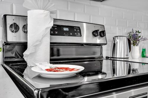 a plate of food sitting on top of a stove at Gorgeous 3-Bed Retreat Mins from Bayside and Parking in Miami
