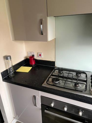 a kitchen with a stove and a counter top at Central Birmingham in Birmingham