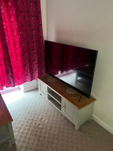 a flat screen tv sitting on a stand in a room at Central Birmingham in Birmingham