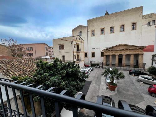 a balcony of a building with cars parked in a parking lot at Giglio luxury apartment in casa professa in Palermo
