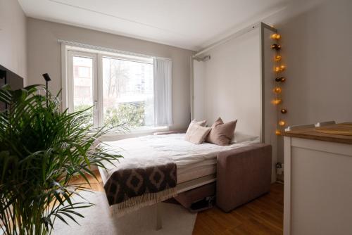 a bedroom with a bed with white sheets and a window at Beautiful home in the heart of Oslo (Grünerløkka) in Oslo