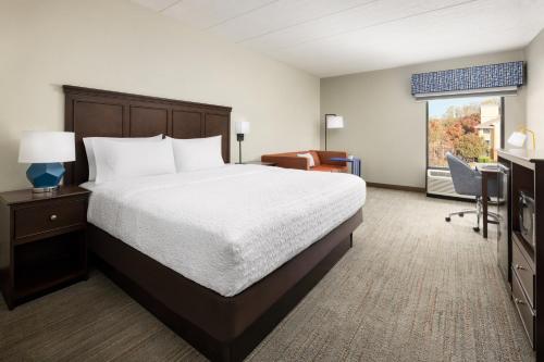 a bedroom with a bed and a desk and a window at Hampton Inn Columbia, MD in Columbia