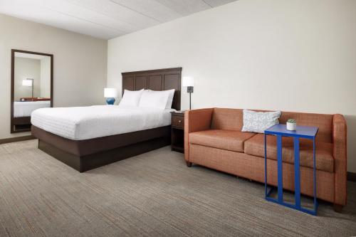 a hotel room with a bed and a couch at Hampton Inn Columbia, MD in Columbia