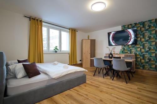 um quarto com uma cama, uma mesa e cadeiras em U Šípků em Ostrava