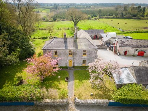 an aerial view of an old house in a field at Marianne Cottage at Johnsfort in Ráistín